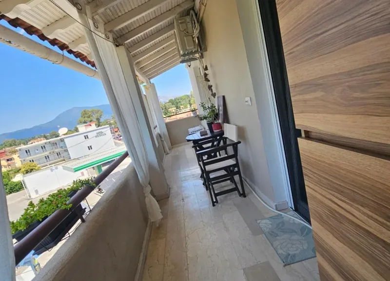Covered balcony at Eda House with bistro table and sea and mountain views