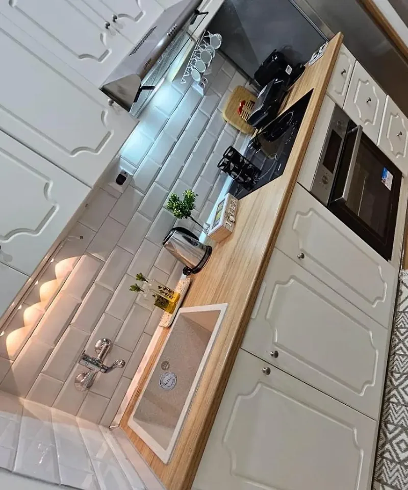 Fully equipped kitchen at Eda House with wooden worktop, sink and coffee machine