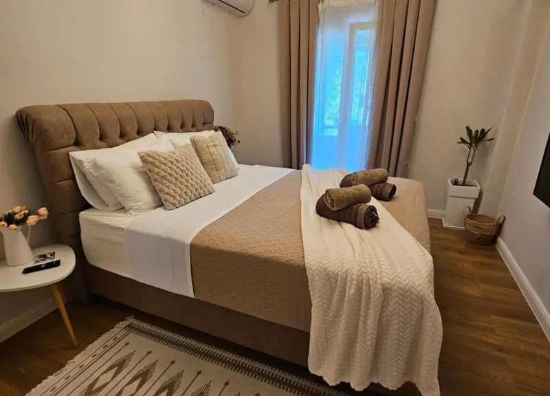 Bedroom at Eda House with an upholstered double bed and fresh towels