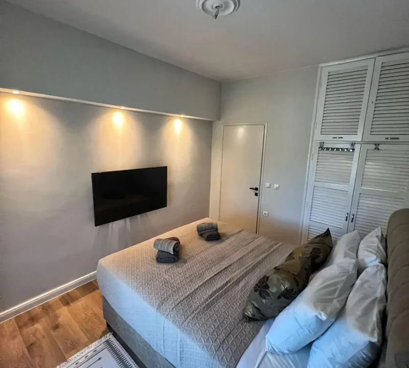 Bedroom at Eda House with flat-screen TV and fitted wardrobe