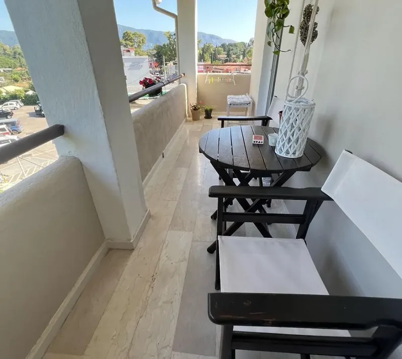 Balcony with bistro table overlooking Gouvia at Eda House