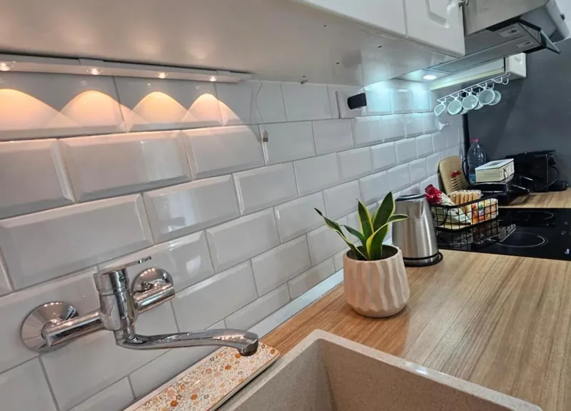 Kitchen worktop with white metro tiles at Eda House
