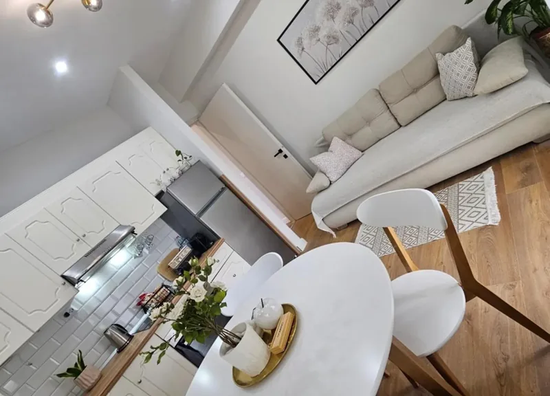 Open-plan living and dining space at Eda House flowing into the kitchen
